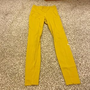 Lululemon leggings in a mustardy yellow